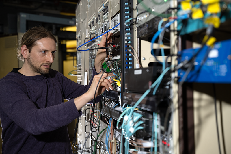 Thorsten Hellert, Physicist Research Scientist/Engineer, Accelerator Technology and Applied Physics (ATAP), adjusting the settings on one of the controls Advanced Light Source (ALS, building 6) at Lawrence Berkeley National Laboratory